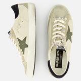 The GOLDEN GOOSE Super Star Nappa Upper Suede Sneakers feature a beige design with olive green stars, black heel patches, white soles, and laces printed with “GOLDEN GOOSE.” One light grey leather sneaker is shown from the side and one from above.
