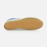 The image shows the sole of a GOLDEN GOOSE Super Star Suede Upper And Nylon Tongue Sneaker, with a tan rubber herringbone tread. The leather lace-up shoe’s side displays “GOLDEN GOOSE” in blue text on white.