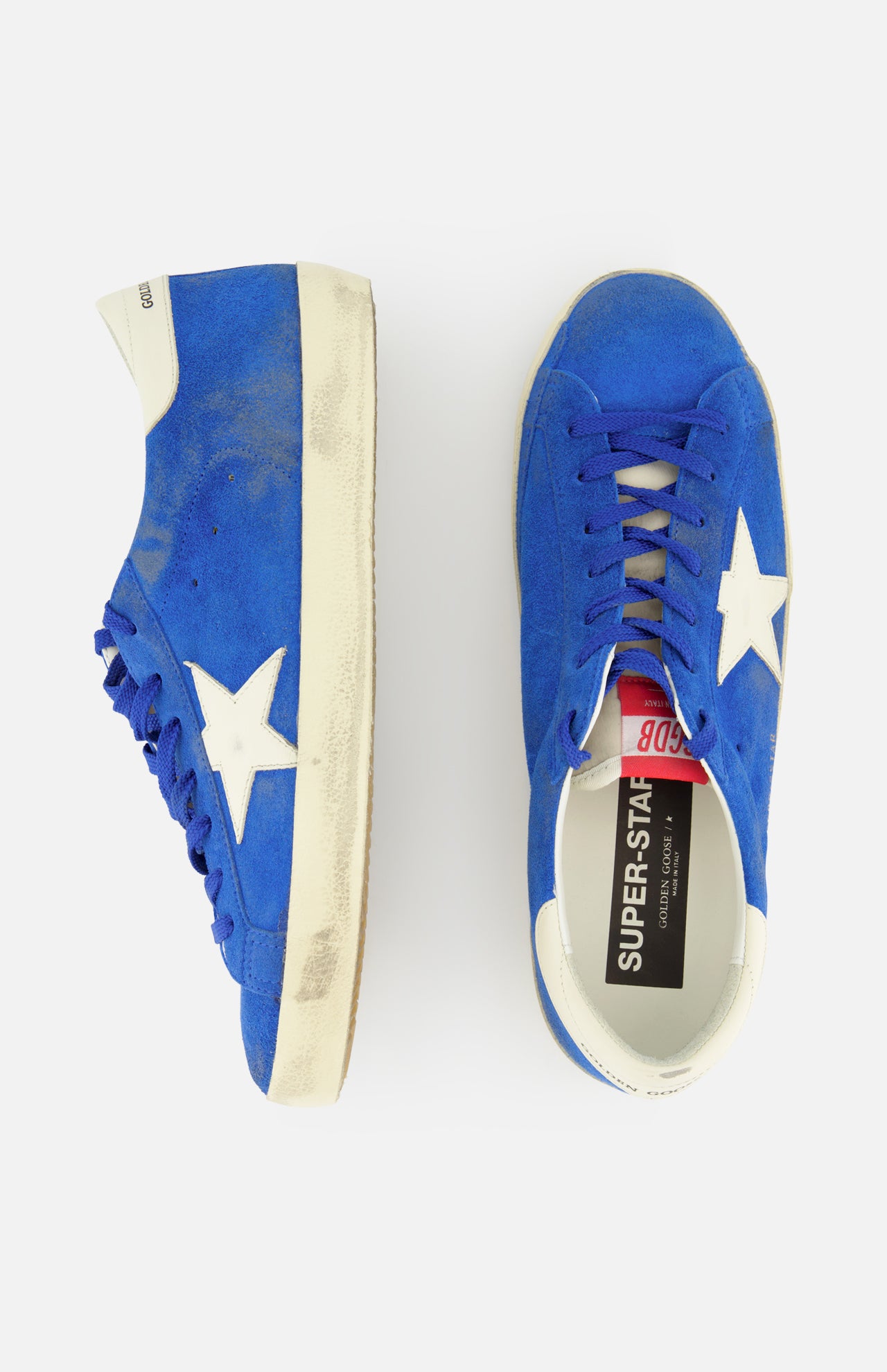 The GOLDEN GOOSE Super Star Suede Upper And Nylon Tongue Sneaker features vibrant blue suede, white star accents, and white soles; shown are a side view and a top view on a plain white background.