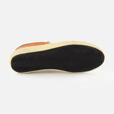 A Super Star Suede Upper Toe and Tongue Sneaker by GOLDEN GOOSE is displayed from the bottom, highlighting its brown upper, black scuffed sole with a zigzag tread pattern, and light beige midsole—all set against a white background in classic Golden Goose style.