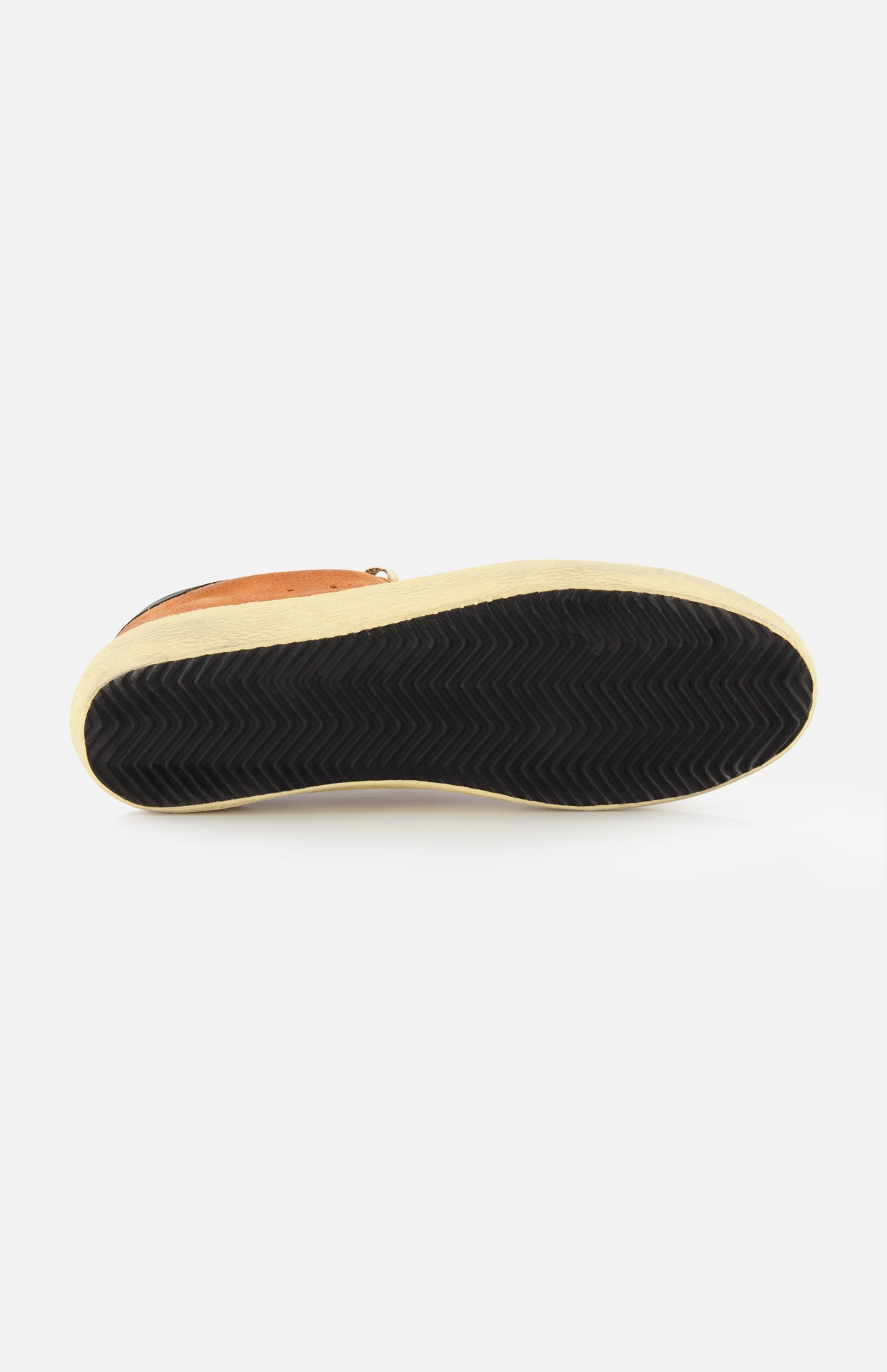 A Super Star Suede Upper Toe and Tongue Sneaker by GOLDEN GOOSE is displayed from the bottom, highlighting its brown upper, black scuffed sole with a zigzag tread pattern, and light beige midsole—all set against a white background in classic Golden Goose style.