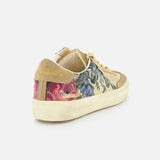 The GOLDEN GOOSE Soul-Star Canvas Sneaker features beige canvas, floral-patterned sides with blue and pink blooms, suede accents, a cream sole, and “GOLDEN SOUL SLUX” in gold on the heel. Shown on a plain white background.
