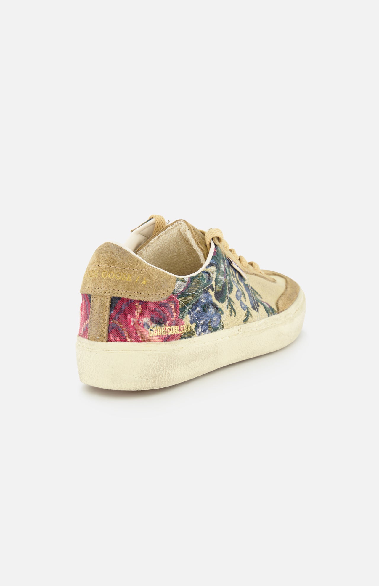The GOLDEN GOOSE Soul-Star Canvas Sneaker features beige canvas, floral-patterned sides with blue and pink blooms, suede accents, a cream sole, and “GOLDEN SOUL SLUX” in gold on the heel. Shown on a plain white background.