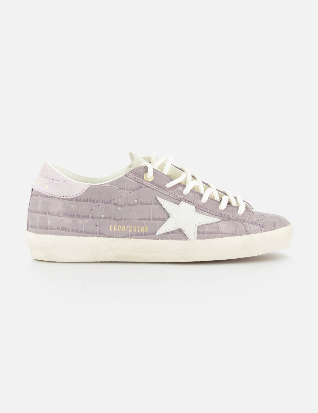 The GOLDEN GOOSE Super Star Crocco Printed Sneaker is shown in mauve with a lilac crocco texture, white laces, a white star on the side, and “GOLDENSTAR” in gold lettering against a plain white background.