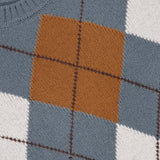 Close-up of the GRAN SASSO Argyle Pattern Crewneck Sweater, crafted from soft virgin wool and made in Italy. This sweater features an argyle pattern with shades of gray, mustard yellow, white, and brown. It is finished with a ribbed neckline and intersecting diagonal lines that form classic diamond shapes.