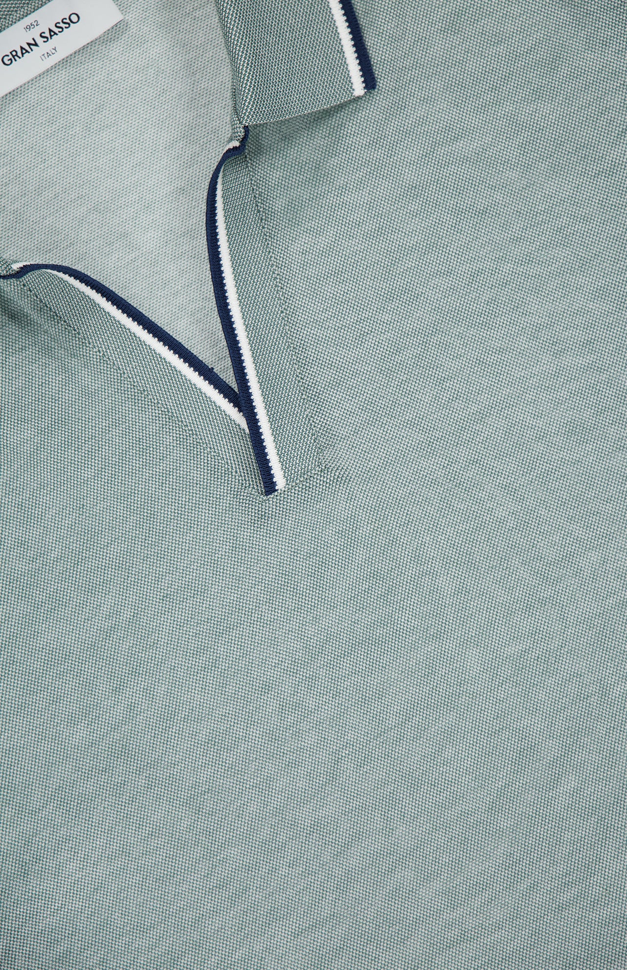 Close-up of the GRAN SASSO Johnny Collar Polo Shirt in light green, featuring a white and navy striped collar, partially unbuttoned. Italian-made quality is displayed in the visible fabric and stitching details.