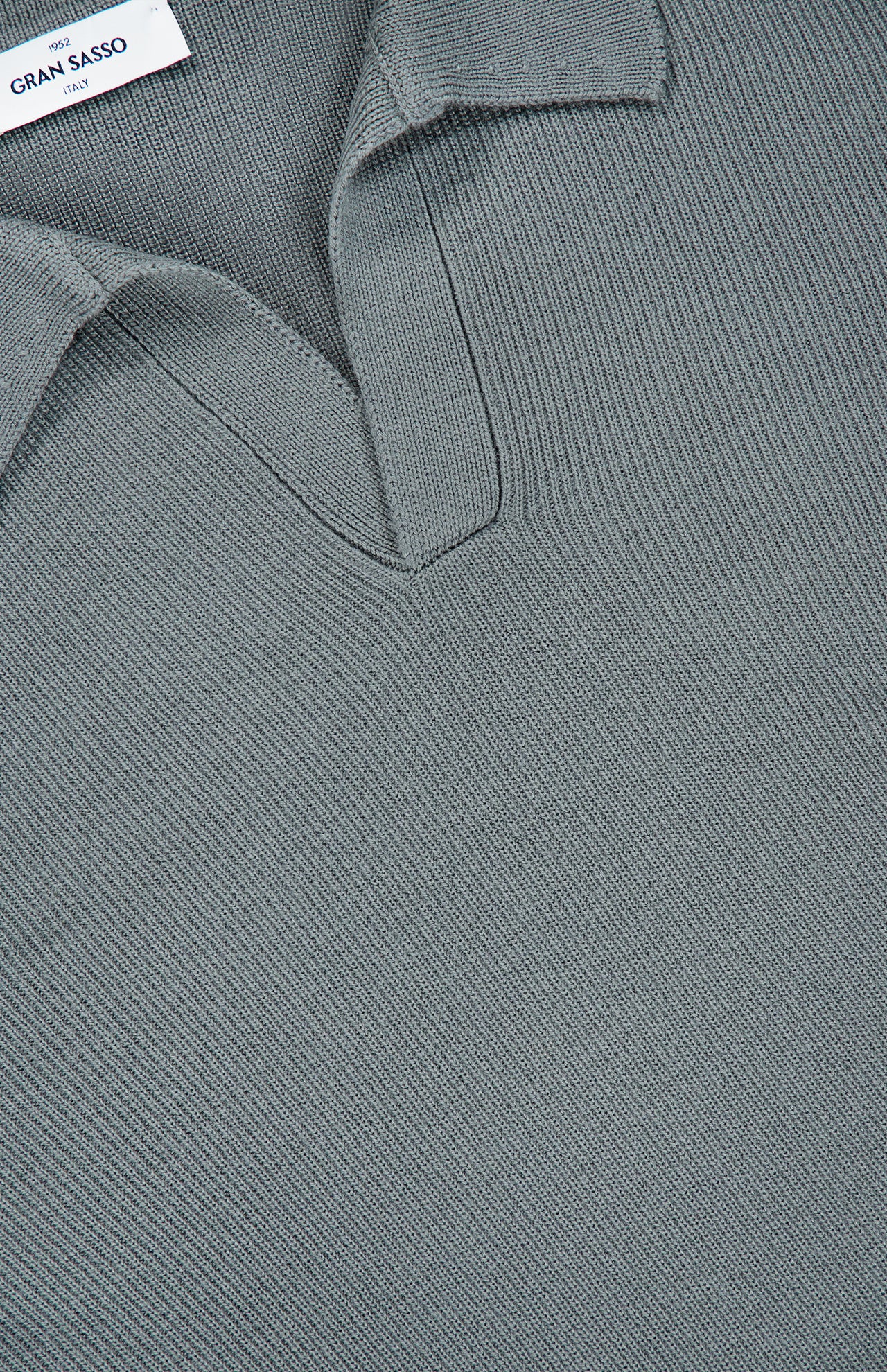 Close-up of the Johnny Collar Polo Sweater by GRAN SASSO in light green, showcasing fine knit detailing and a visible GRAN SASSO label at the neckline.
