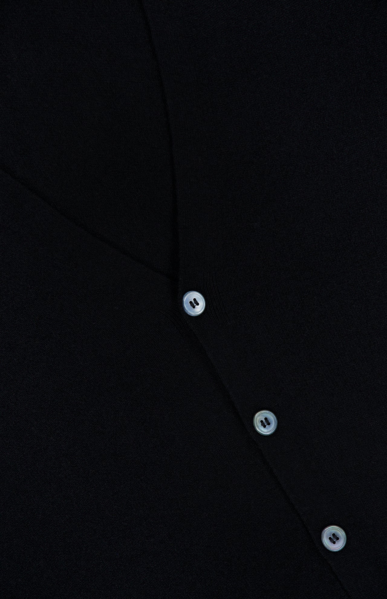 Close-up of the GRAN SASSO Light Cardigan Sweater, crafted in Italy from a black wool blend, featuring three visible white buttons along a diagonal seam.