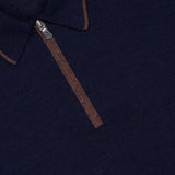 Close-up of a GRAN SASSO Quarter Zip Polo Sweater in navy blue, crafted in Italy, featuring a brown zipper and trim detail on the collar. The visible collar label emphasizes its premium wool-silk blend construction.
