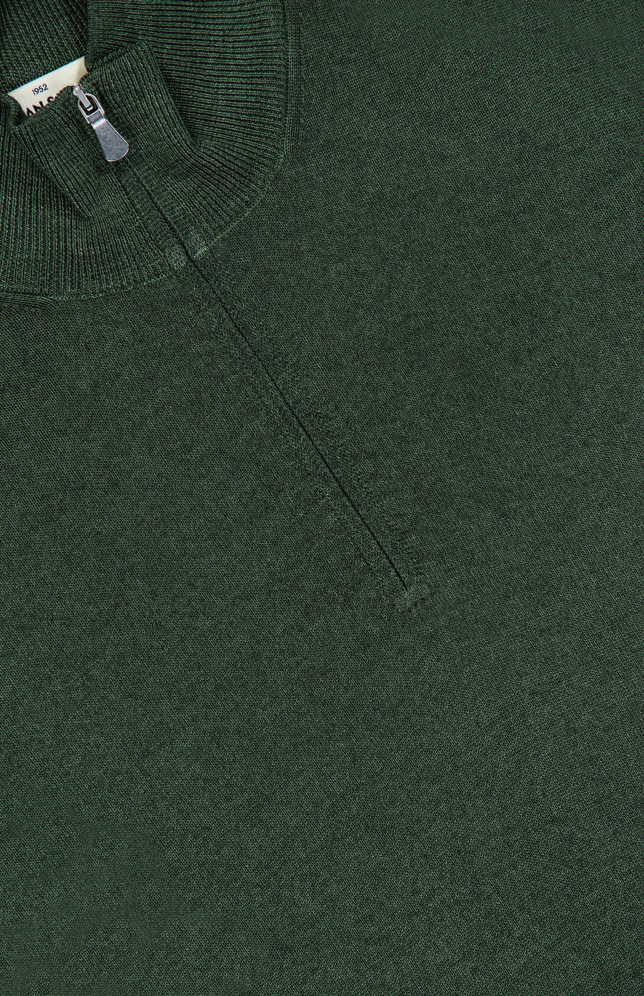 A close-up of the GRAN SASSO Quarter Zip Wool Sweater in dark green, made in Italy, featuring a partially closed zipper and the collar. The fabric looks soft and textured.