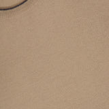 Close-up of the Suede Elbow Patch Crewneck Sweater by GRAN SASSO, featuring a tan knit made from soft virgin wool and a round neckline. A small white clothing label is visible at the top left corner.