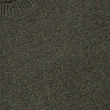 Close-up of a textured, dark green Tonal Fair Isle Sweater with a round neckline, featuring a visible GRAN SASSO brand label sewn into the collar.
