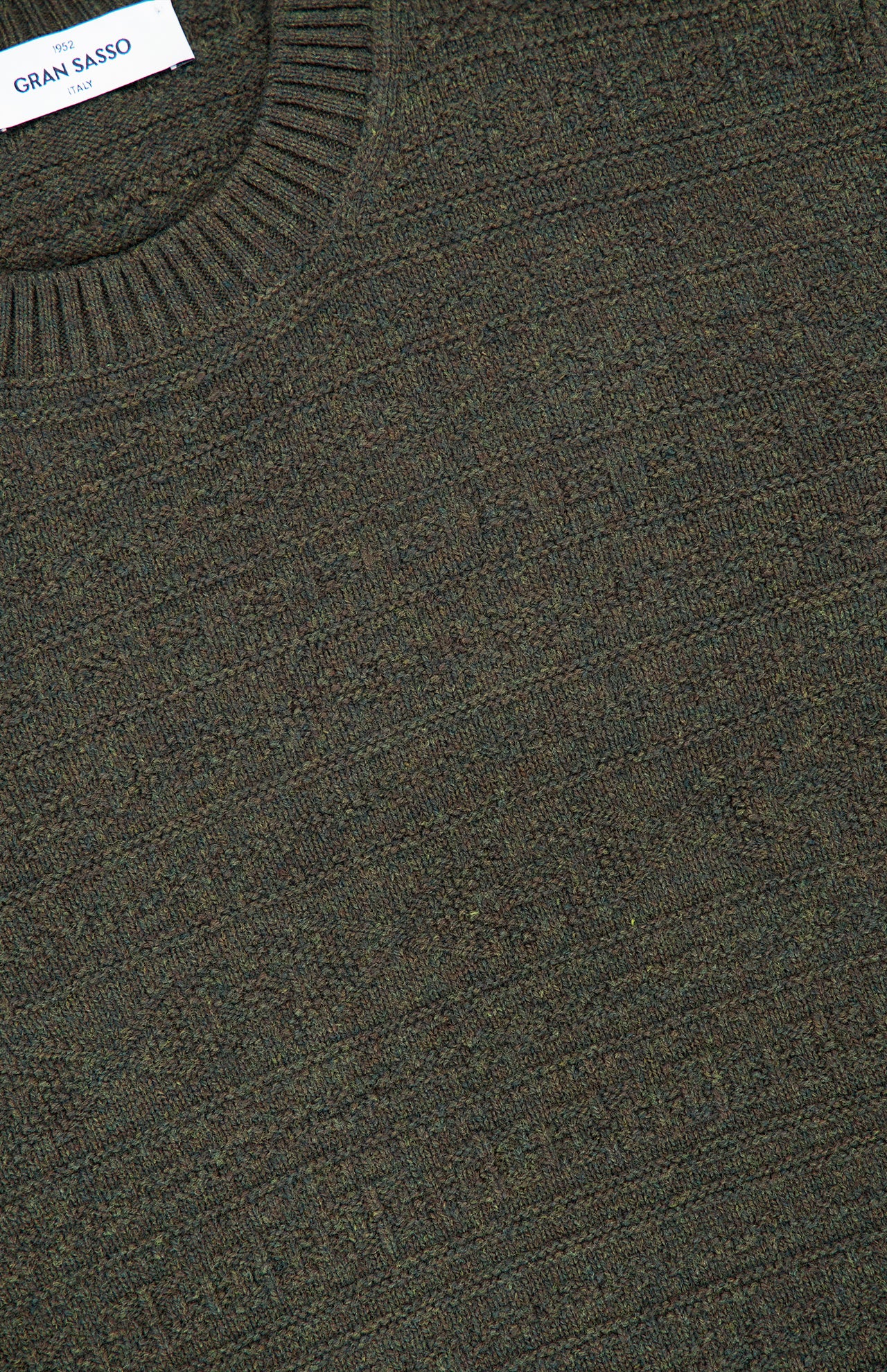 Close-up of a textured, dark green Tonal Fair Isle Sweater with a round neckline, featuring a visible GRAN SASSO brand label sewn into the collar.