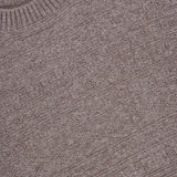 A close-up view of a brown GRAN SASSO Tonal Fair Isle Sweater, highlighting the textured fabric pattern and ribbed crew neckline.