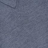 Close-up of a light grey GRAN SASSO V-Neck Virgin Wool Sweater, crafted from fine knit fabric and displaying its soft texture, with part of a white label and partial text visible in the upper left corner.