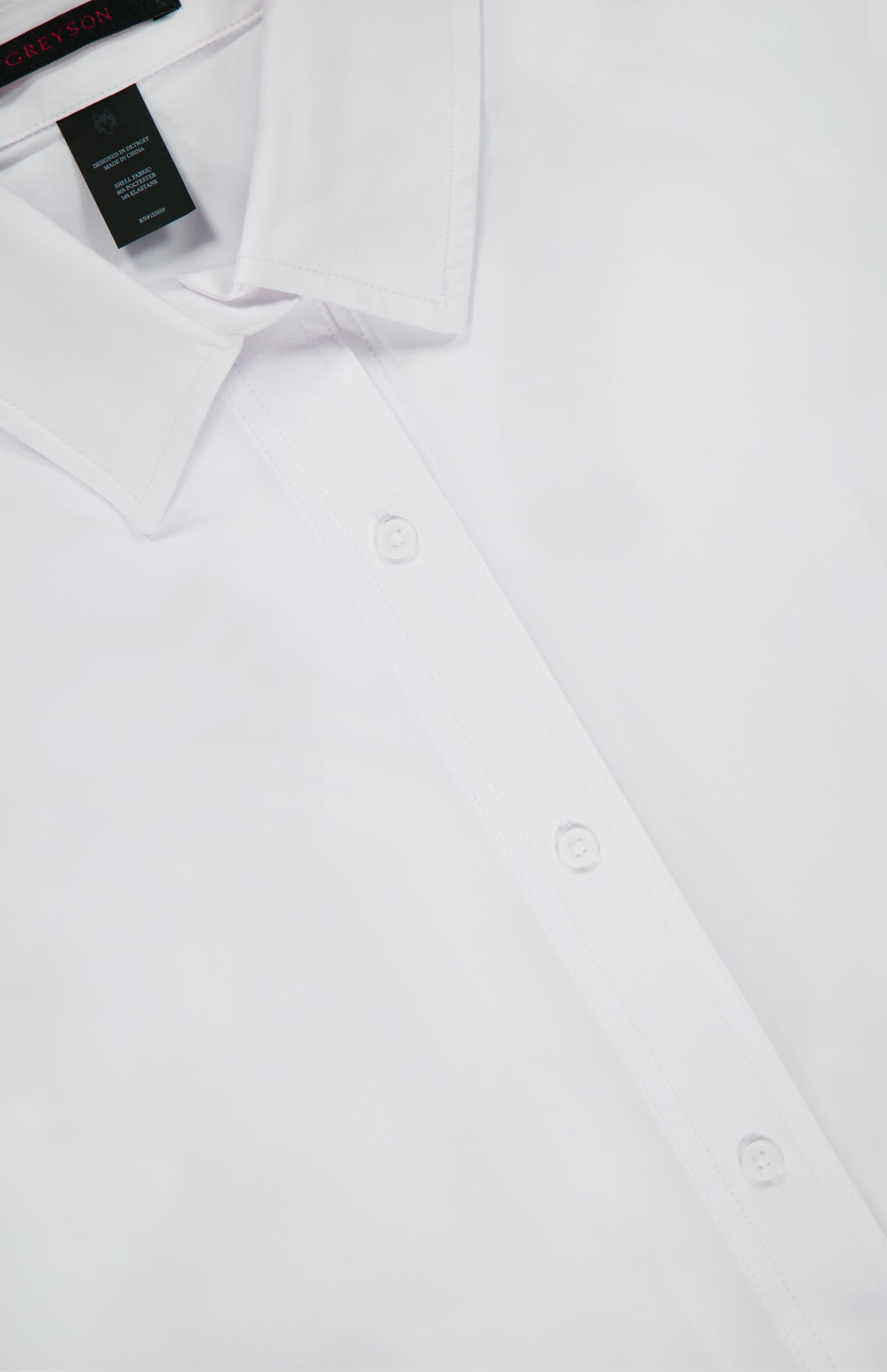 Close-up of the Ashe Button Down Shirt by GREYSON in white, featuring the collar, front buttons, and a glimpse of the neck label. This tailored summer shirt is displayed neatly against a plain background.