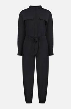 The GREYSON Phoenix Jumpsuit is a stylish black one-piece with a collared neckline, chest pockets, belted waist tie, and tapered legs, crafted from lightweight silky fabric and shown against a white background.