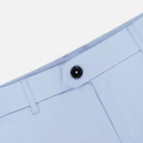 Close-up of the GREYSON 8 Inch Montauk Short’s waistband in light blue, showing a black button, belt loops, and stitching. Crafted from stretch breathable fabric for comfort and style, set against a white background.