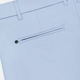 Close-up of the back of the GREYSON 8 Inch Montauk Short in light blue, showing a single welt pocket with button closure and belt loops, made from stretch breathable fabric for all-day comfort.