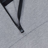 Close-up of the GREYSON Calgary Quarter Zip Sweatshirt in grey, featuring a partially unzipped black zipper that reveals black mesh lining with a subtle camo pattern—crafted for thermal insulation and understated style.