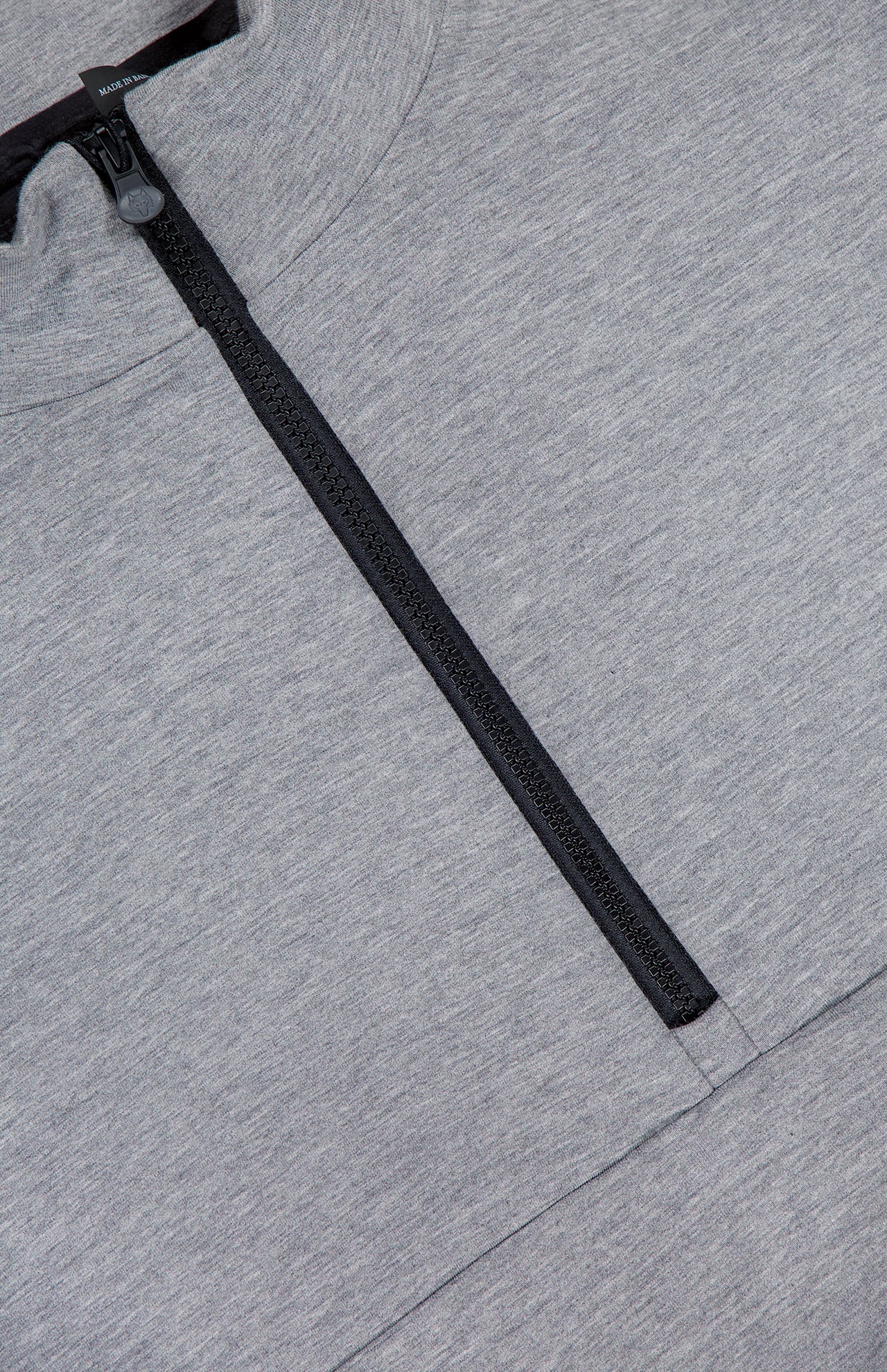 Close-up of the GREYSON Calgary Quarter Zip Sweatshirt in heather gray, featuring a black quarter-zip partially open, highlighting the fabric texture, seam detail beneath the zipper, and subtle thermal insulation for comfort.