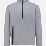 The GREYSON Calgary Quarter Zip Sweatshirt features thermal insulation, a high collar, and an angled black utility pocket on the lower left. Its light gray color and minimal design deliver warmth and functionality with a modern touch.