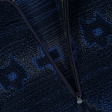 Close-up of a navy and blue geometric sherpa fleece fabric, partially unzipped to reveal the inner lining and a GREYSON label near the collar—an elevated detail that distinguishes the men’s Guardian Sherpa Fleece Half Zip Sweater.