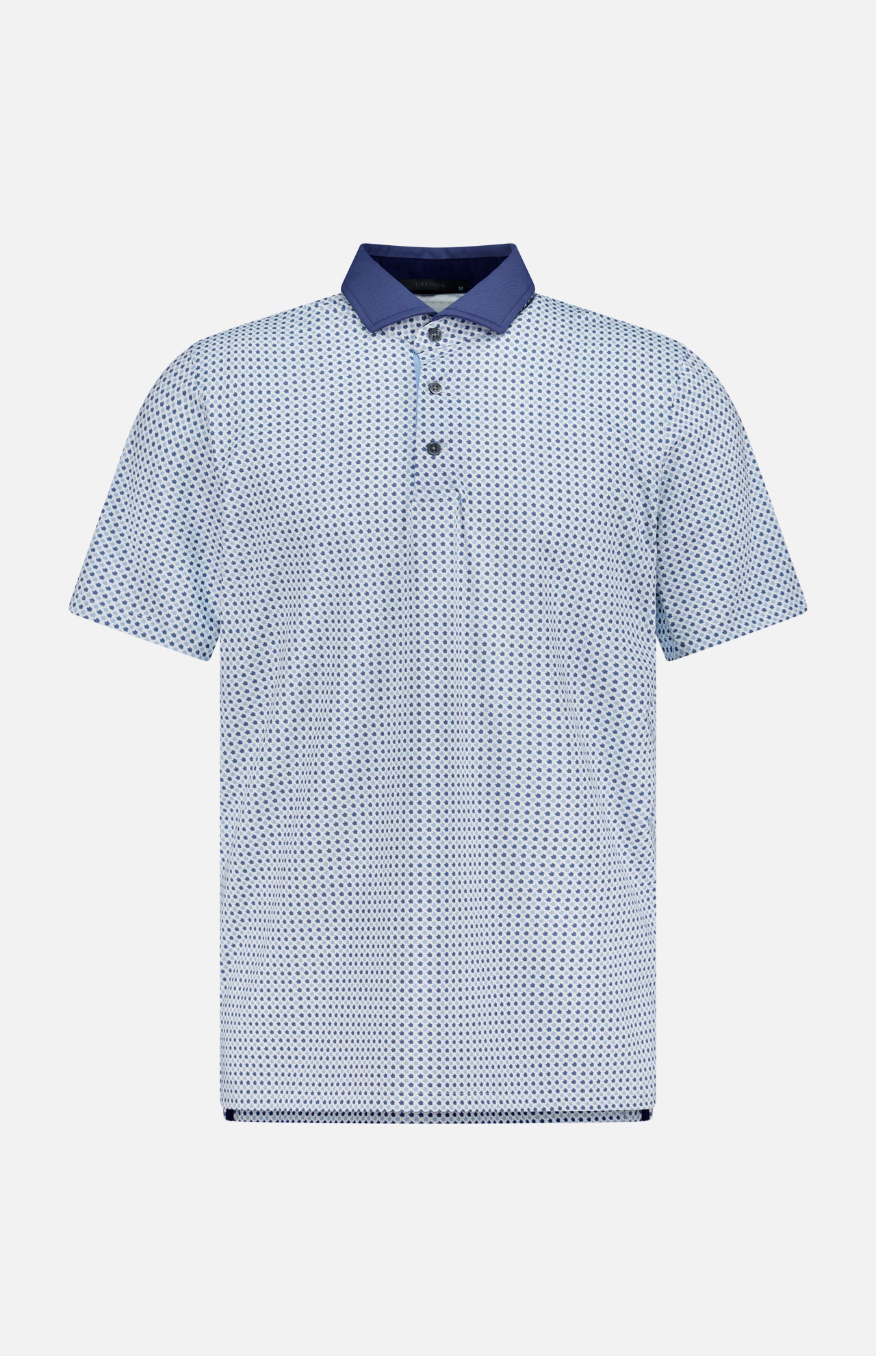 The GREYSON Ironwood Polo Shirt features a light blue short-sleeve design with a dark blue geometric pattern, button-up placket, and solid dark blue collar. Moisture-wicking fabric offers UV protection. Shown on a plain white background.