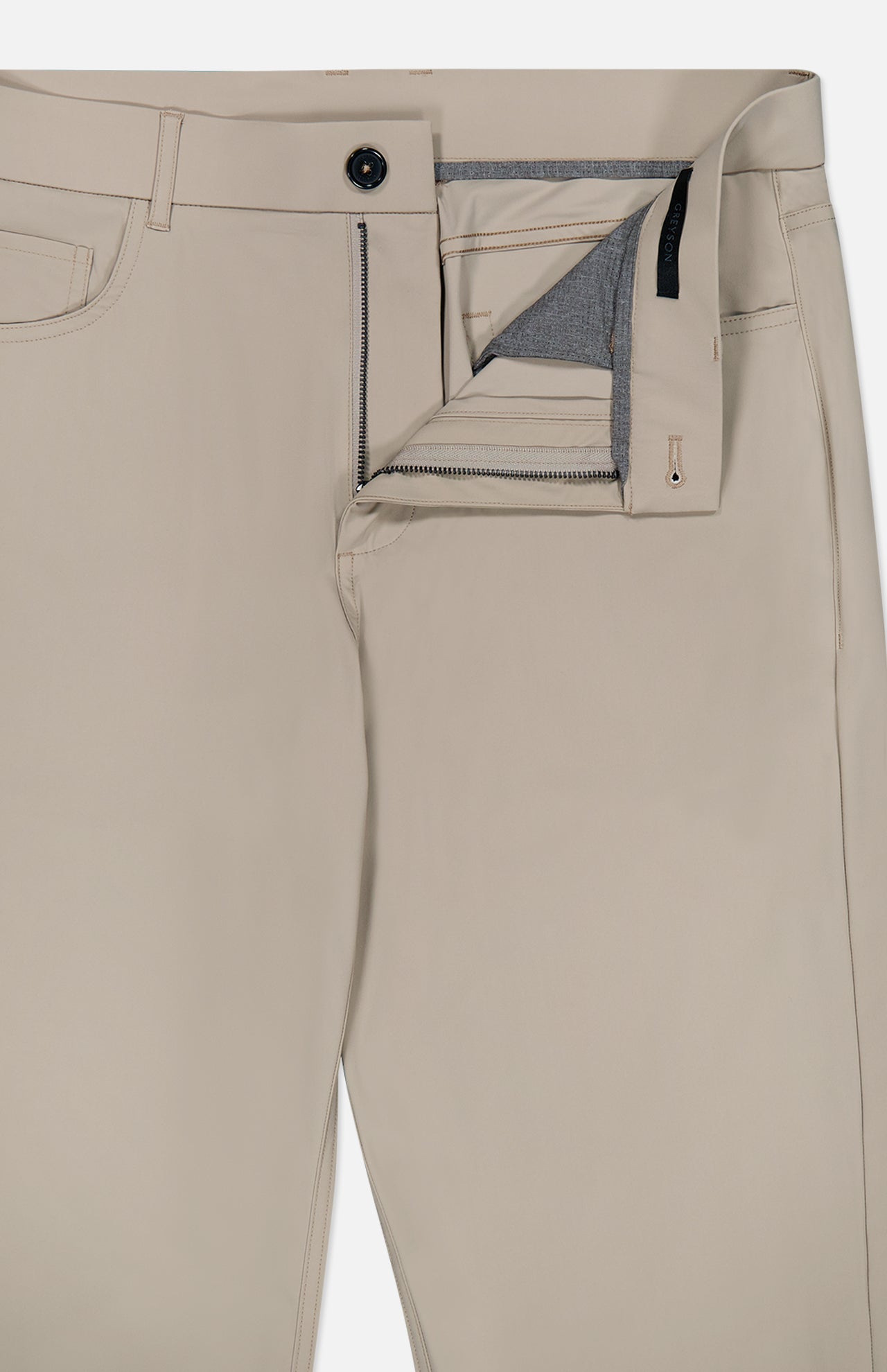 The Montauk 5 Pocket Pant by GREYSON is crafted from premium Italian fabric in beige, shown laid flat on a white background with the zipper and top button undone to reveal the inside waistband and pocket lining.