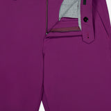 Close-up of the GREYSON Montauk 8-Way Stretch Trouser in magenta, featuring an open fly with zipper, grey striped inner lining, and a visible black and magenta button at the waistband.