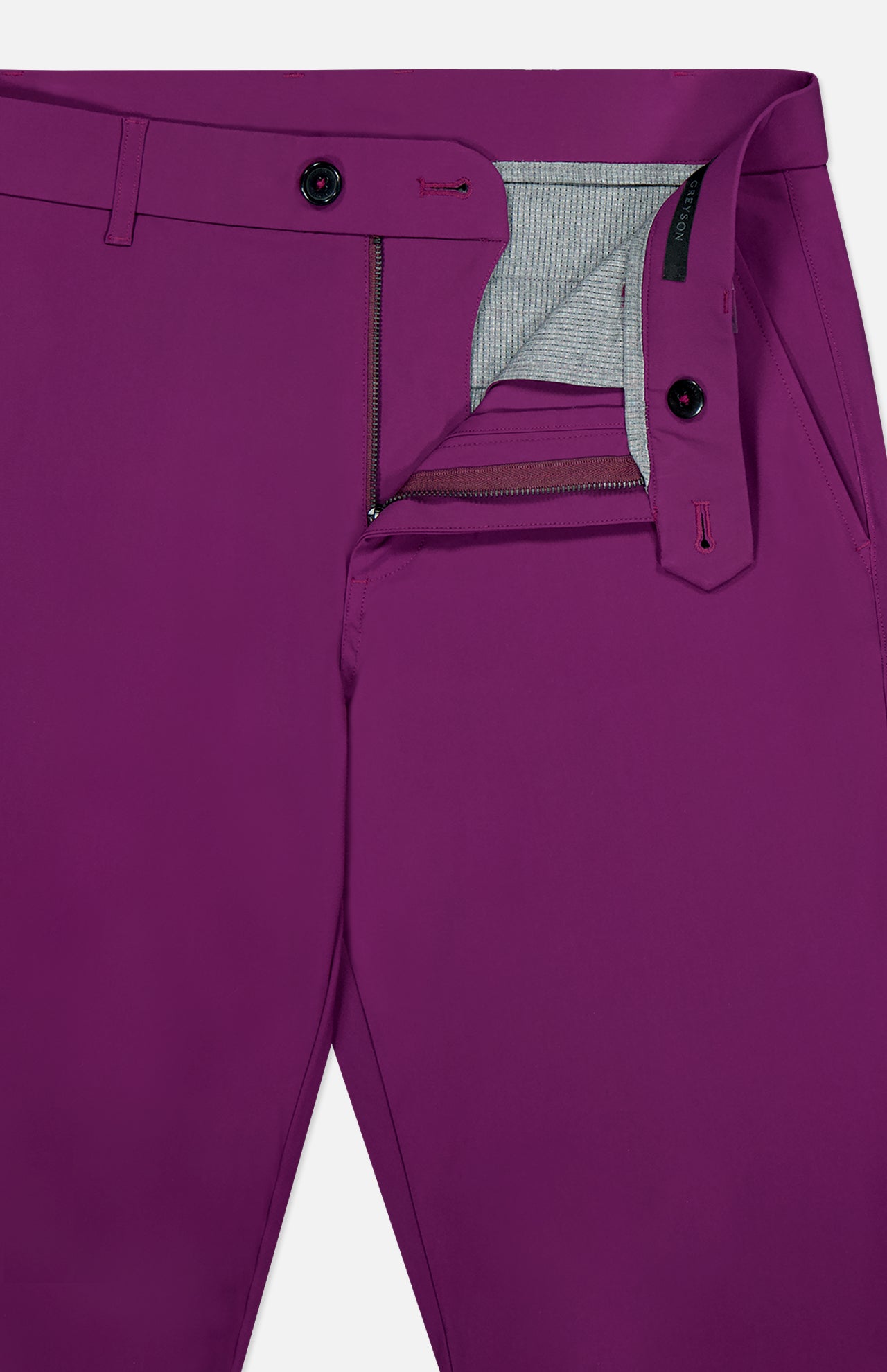 Close-up of the GREYSON Montauk 8-Way Stretch Trouser in magenta, featuring an open fly with zipper, grey striped inner lining, and a visible black and magenta button at the waistband.