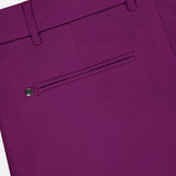 Close-up of the back of GREYSON Montauk 8-Way Stretch Trouser in magenta, showing a buttoned single welt pocket and belt loops on the waistband.