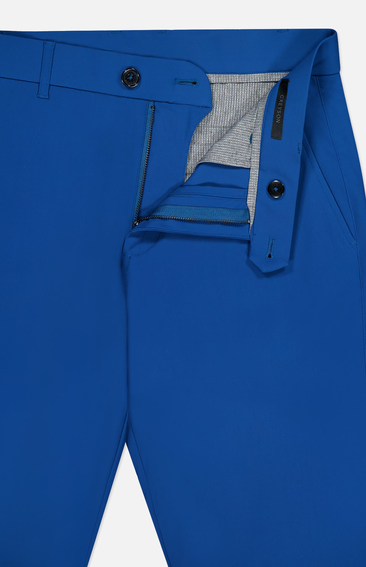 Close-up of GREYSON Montauk 8-Way Stretch Trouser in dark blue with open zipper and button, revealing gray lining and waistband. Made from Italian fabric, these trousers offer belt loops, side pockets, and refined detailing.