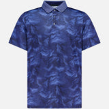 GREYSON’s Smoke In The Den Polo Shirt is a short-sleeve performance polo featuring a blue and purple marble-like swirl pattern and a buttoned collar. Crafted from moisture-wicking fabric for enhanced comfort, the shirt is presented against a plain, light gray background.