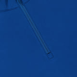 A close-up of the GREYSON Tate Quarter Zip shows its dark blue, smooth Italian technical fabric with UV protection, featuring a partially unzipped zipper and slightly open collar.