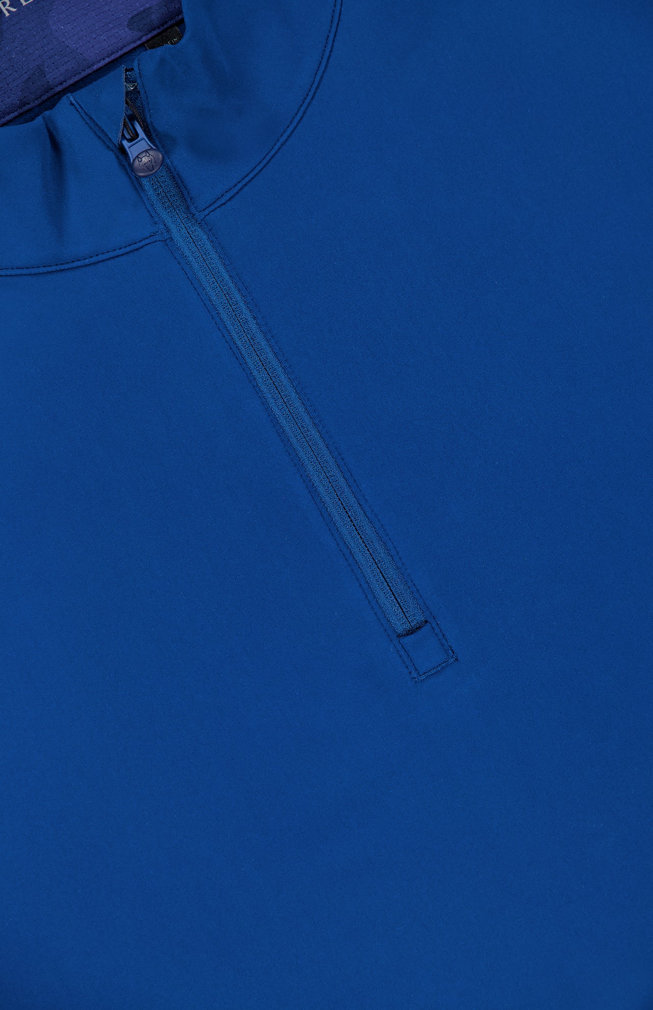 A close-up of the GREYSON Tate Quarter Zip shows its dark blue, smooth Italian technical fabric with UV protection, featuring a partially unzipped zipper and slightly open collar.