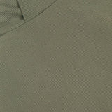 Close-up of the olive green textured fabric from the GREYSON Traverse Waffle Hoodie Sweatshirt, highlighting a visible seam and an overlapping fold in the upper left corner.