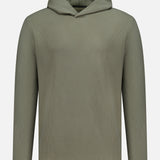 The GREYSON Traverse Waffle Hoodie Sweatshirt is an olive green polyester-blend with a minimalist ribbed texture, v-shaped neckline, and dark accent cuffs featuring tiny white dots.
