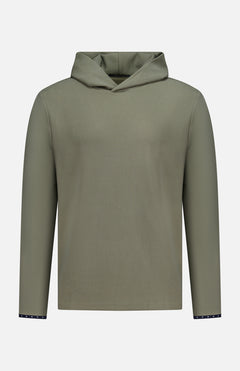 The GREYSON Traverse Waffle Hoodie Sweatshirt is an olive green polyester-blend with a minimalist ribbed texture, v-shaped neckline, and dark accent cuffs featuring tiny white dots.