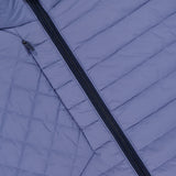 Close-up of the GREYSON Yukon Hybrid Jacket in light purple, featuring a diagonal black zipper and stitching lines that create small rectangular panels on the lightweight technical fabric.