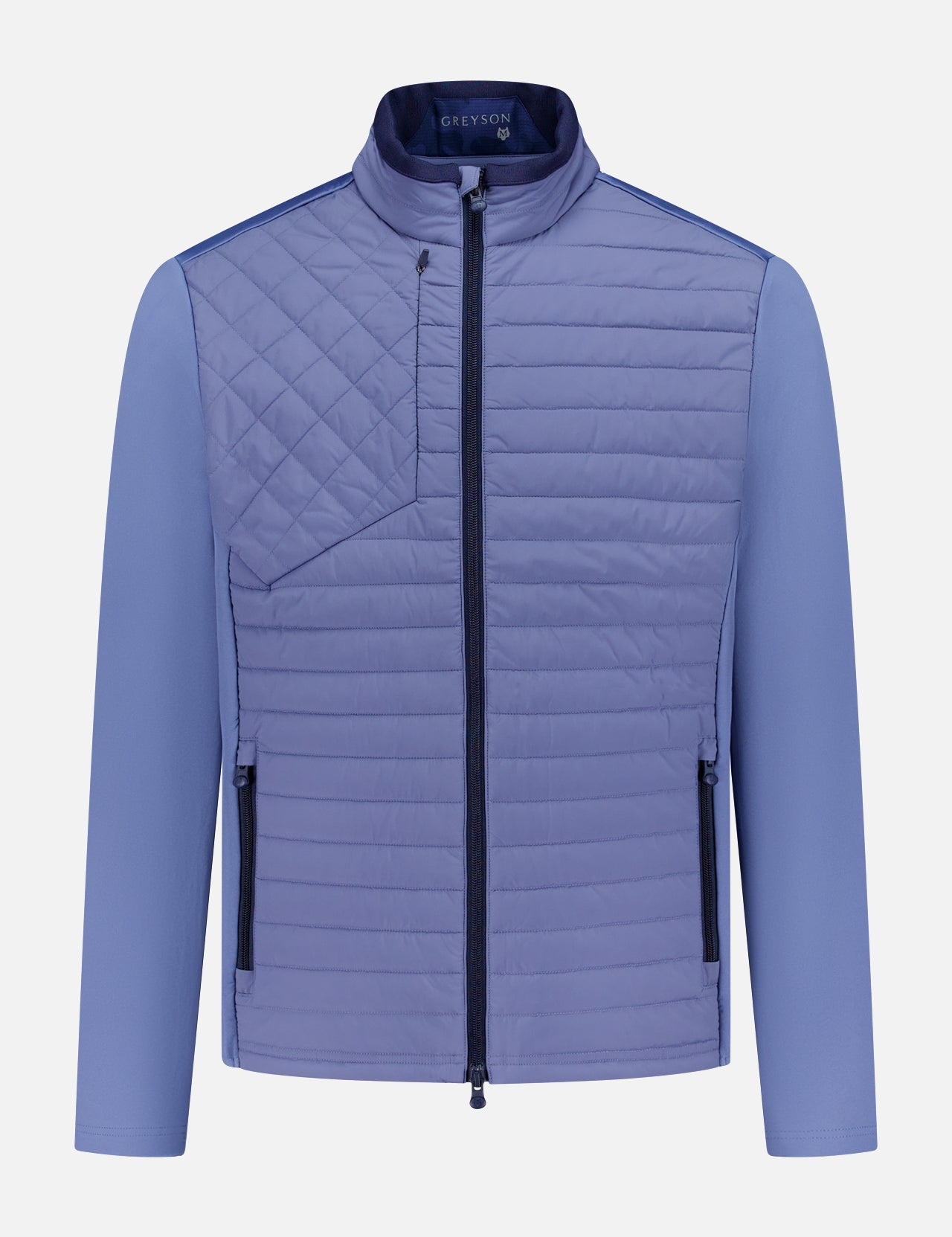 The GREYSON Yukon Hybrid Jacket is a lightweight, light purple technical jacket with Primaloft insulation, high collar, vertical zip pockets at each side, a diagonally stitched chest pocket, smooth long sleeves, and a central front zipper.