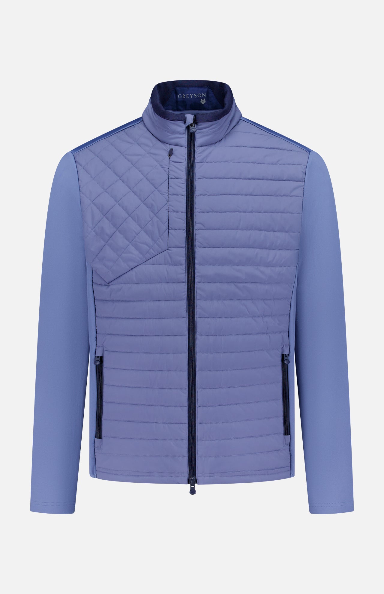 The GREYSON Yukon Hybrid Jacket is a lightweight, light purple technical jacket with Primaloft insulation, high collar, vertical zip pockets at each side, a diagonally stitched chest pocket, smooth long sleeves, and a central front zipper.