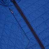 Close-up of the GREYSON Yukon X-Lite Vest in blue, showcasing a central black zipper, grid-patterned stitching on water-resistant fabric, and Primaloft insulation for extra warmth.