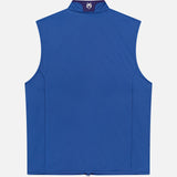 The GREYSON Yukon X-Lite Vest is a sleeveless royal blue hybrid vest with Primaloft insulation, a high collar, and a white and purple embroidered wolf head logo at the back center. It features a smooth, minimalist design.
