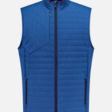 The GREYSON Yukon X-Lite Vest is a sleeveless, quilted blue hybrid vest with Primaloft insulation, featuring a front zipper, two zippered side pockets, a zippered chest pocket, and a stand-up collar. Displayed on a plain white background.