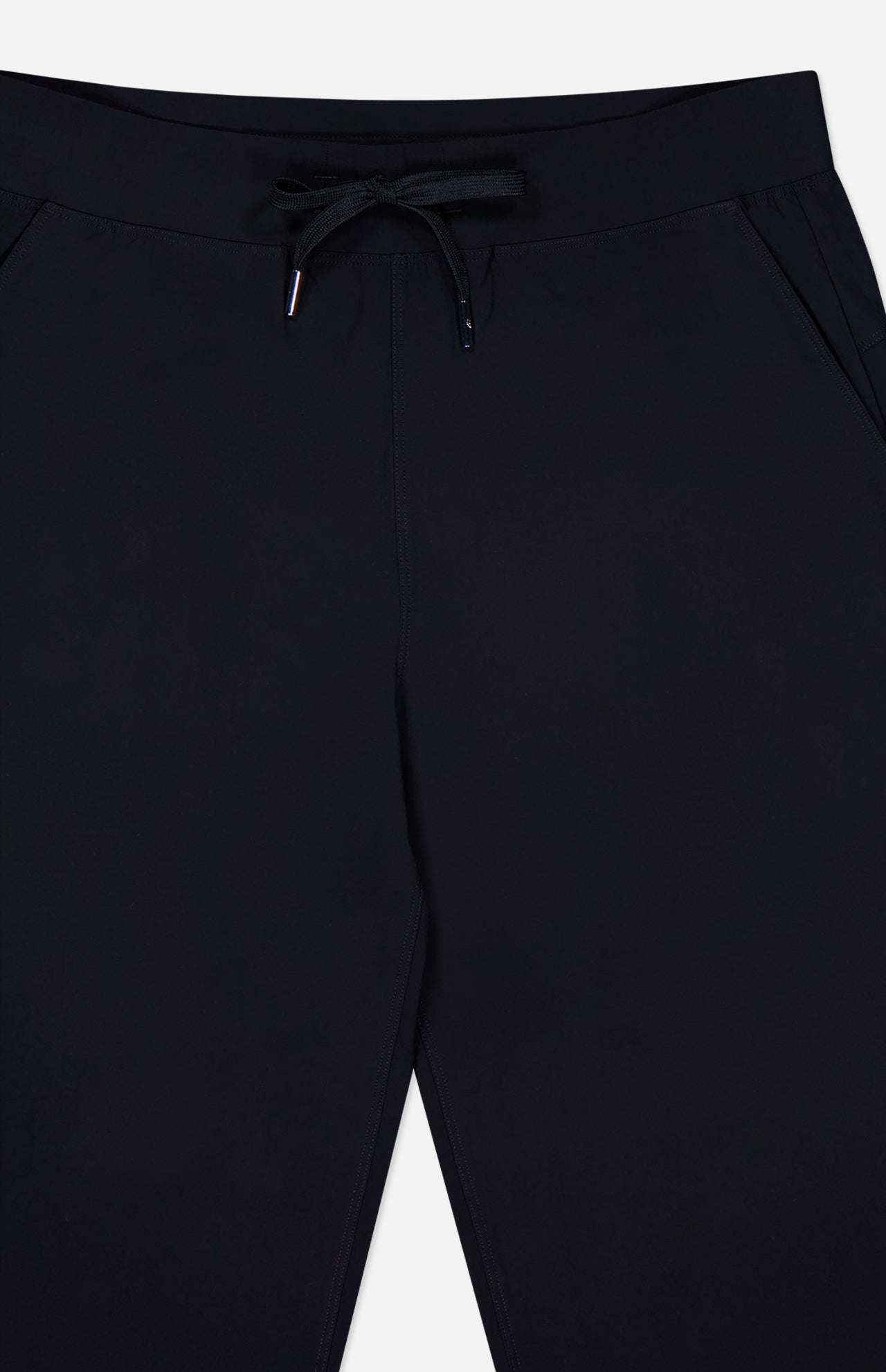 The GREYSON Phoenix Jogger is shown from waist to mid-thigh, featuring side pockets and a lightweight waistband. Its flat, smooth finish and tapered fit give these pants a simple, minimalist look.