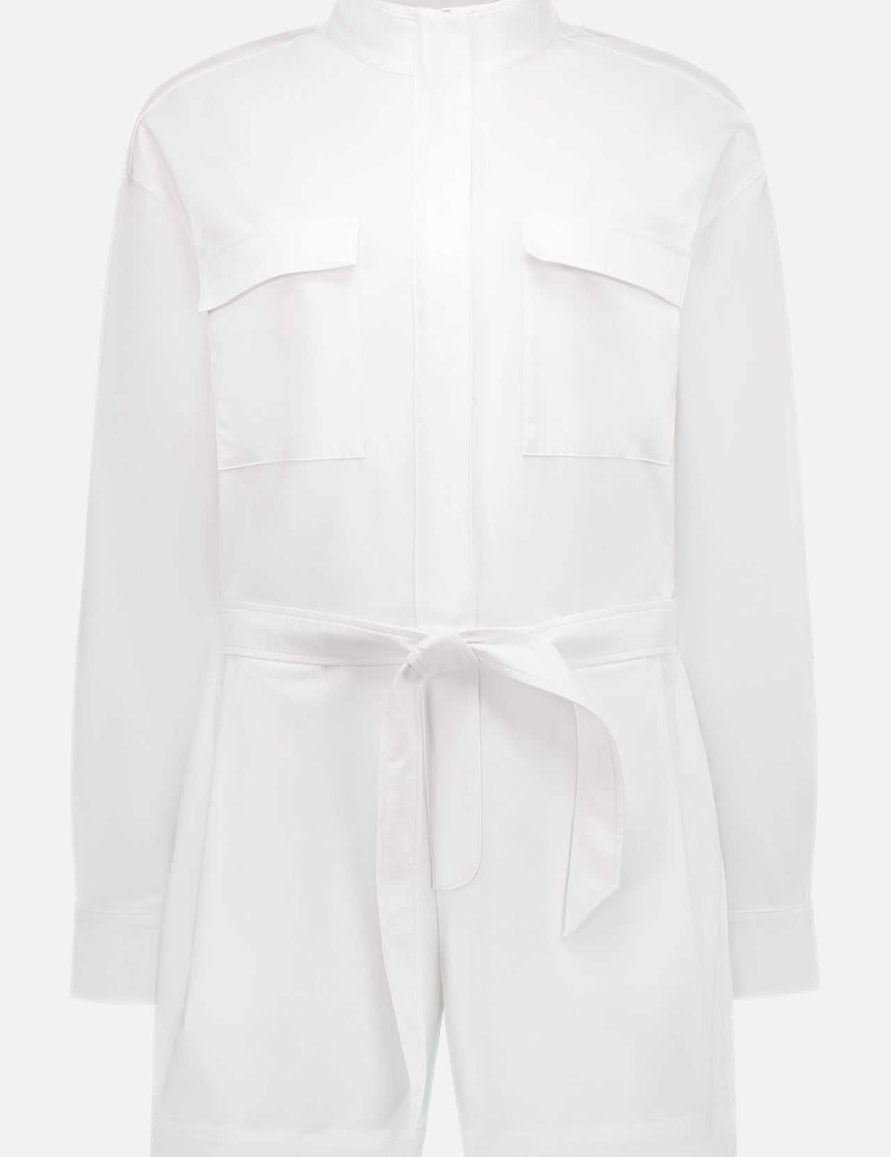The Phoenix Romper by GREYSON is a white long-sleeve shirt dress with a mandarin collar, chest pockets, and a matching belt. Made from breathable fabric, this minimalist one-piece offers versatile and effortless style.