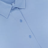 Close-up of the GREYSON Ashe Button Down Shirt in light blue, featuring a neatly pressed collar and three buttons on the front placket. The fabric appears smooth and crisp.