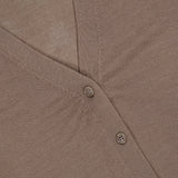 Close-up of a taupe V-neck button-down wool silk Greyson Leith Merino Cardigan Sweater.