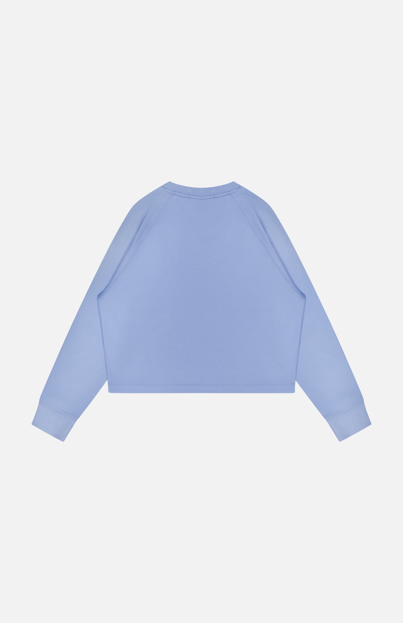 The GREYSON Ojai Cropped Crewneck Sweatshirt is shown from the back against a plain white background. It features a light blue color, long sleeves, and cotton-blend fabric with a simple design and no visible logos or patterns.